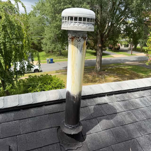 Aged roof-mounted vent termination on a shingle roof