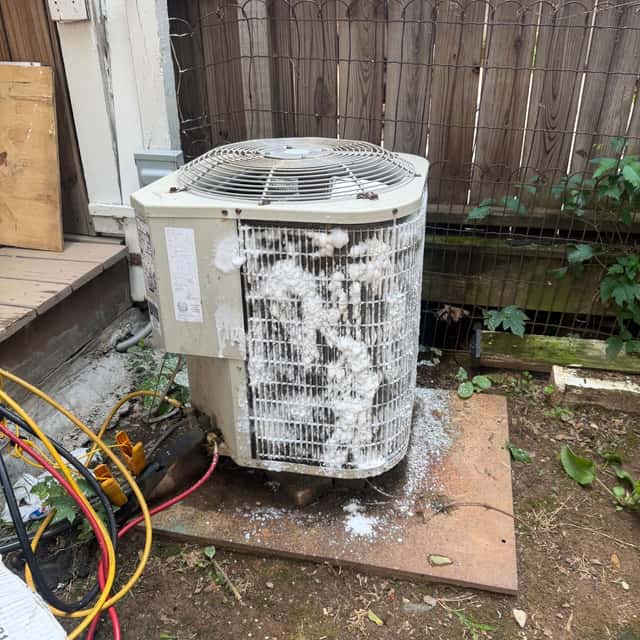 Condenser with refrigerant hoses connected, coil cleaning in progress